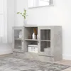 A concrete gray sideboard with glass doors and shelves, placed on a rug in a room. Produktbild-Vorschau