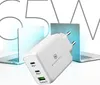 A white 65W GaN charger is shown in the foreground, with two laptops in the background, suggesting its use for charging laptops and other devices. Produktbild-Vorschau