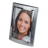 A silver-colored photo frame with a woman's portrait inside, set against a white background. Produktbild-Vorschau
