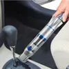 A person is cleaning the interior of a car with a handheld vacuum cleaner. Náhled obrázku produktu