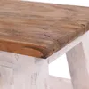A close-up view of the corner of a wooden stool with a natural wood top and a distressed white base. Náhľad obrázku produktu