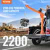 A truck crane lifting an engine at a construction site. Anteprima dell’immagine prodotto