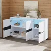 A white and black modern sideboard with its doors open, displaying interior shelves and decorative items, set against a wood-paneled wall. Voir les images du produit