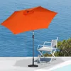 An orange umbrella and a white chair are set up on a patio overlooking the ocean. Produktbild-Vorschau
