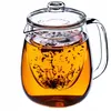 A glass teapot filled with amber-colored tea and loose tea leaves in an infuser. Anteprima dell’immagine prodotto
