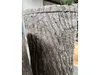 A close-up view of a brown, tree-stump-shaped water butt. Produktbild-Vorschau
