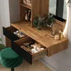 A vanity table with makeup and accessories, a stool, and a mirror with LED lighting. Voir les images du produit