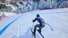 A skier is descending a snowy mountain slope, with trees and rocky terrain in the background. Náhled obrázku produktu
