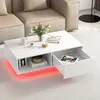 A white coffee table with an open drawer and LED lighting is shown in a living room setting. Voir les images du produit
