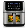 A stainless steel air fryer with a digital display and a window showing vegetables inside. Voir les images du produit
