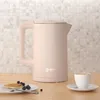 A pink electric kettle is shown on a wooden countertop with a small plate of pancakes and berries, and a cup of coffee. Produktbild-Vorschau