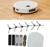 A robot vacuum cleaner and its accessories are displayed on a wooden floor. Anteprima dell’immagine prodotto