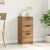A wooden cabinet with three drawers is shown in a room with a chair and a plant. Anteprima dell’immagine prodotto