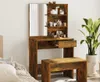 A vanity table with a mirror and a stool, set up in a room with a plant and a bed. Produktbild-Vorschau