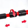 A close-up of a red telescopic pole with black adjustable grips, showing how to extend or retract it. Produktbild-Vorschau