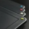 A close-up, angled view of a set of dark gray cutting boards with colored dots on the corners. Anteprima dell’immagine prodotto