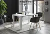 A modern dining room with a white table and black chairs. Produktbild-Vorschau