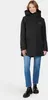A woman wearing a black parka and blue jeans stands against a white background. Produktbild-Vorschau
