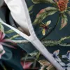 A close-up view of a duvet cover with a floral and bee pattern, showing a zipper. Náhľad obrázku produktu