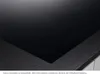 A close-up view of a black glass-ceramic cooktop with a textured gray edge. Anteprima dell’immagine prodotto