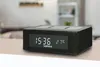 A black Lenco CR-580BK stereo FM-radiowecker with a digital display showing the time and temperature, placed on a light-colored surface. Produktbild-Vorschau