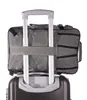 A close-up view of a gray travel backpack attached to the handle of a larger suitcase. Podgląd zdjęcia produktu