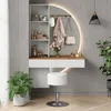 A vanity table with a mirror, stool, and accessories. Voir les images du produit