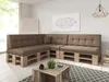 A modern living room with a sectional sofa made of pallets and brown cushions, a coffee table made of wooden crates, and a geometric art piece on the wall. Produktbild-Vorschau