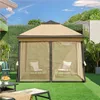 A gazebo with mesh walls is set up on a green lawn in a backyard, with chairs inside. Produktbild-Vorschau