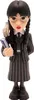 A figurine of Wednesday Addams holding a book, with her hand puppet Thing on her shoulder. Podgląd zdjęcia produktu