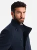 A man wearing a navy blue coat. Anteprima dell’immagine prodotto