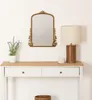 A decorative mirror and a lamp are displayed on a console table. Anteprima dell’immagine prodotto