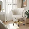 A cream-colored velvet office chair with a gold base is placed in a well-lit room with sheer curtains and a small desk. Produktbild-Vorschau