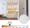 A modern kitchen with white cabinets and under-cabinet lighting, next to a color temperature scale and a light bulb. Produktbild-Vorschau
