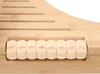 A close-up view of a wooden footrest with rollers. Náhled obrázku produktu