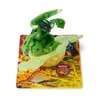 A green Bakugan toy is displayed on a card with a fiery background. Podgląd zdjęcia produktu