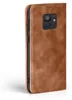 A brown leather flip case for a smartphone is shown against a white background. Produktbild-Vorschau