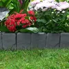 A garden border with flowers and grass. Produktbild-Vorschau