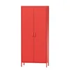 A tall, red metal wardrobe with two doors and thin metal legs, shown against a white background. Podgląd zdjęcia produktu
