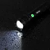 A black Vayox flashlight is shown on a wet black surface, with its light beam illuminating the water droplets. Náhled obrázku produktu
