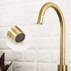 A close-up of a gold kitchen faucet with water running. Produktbild-Vorschau