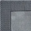 A close-up view of a rug with a chevron pattern on one side and a checkered pattern on the other. Produktbild-Vorschau