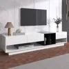 A modern white TV stand with a black cube insert, featuring a TV mounted on a marble-patterned wall. Produktbild-Vorschau