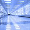 A long, empty, brightly lit corridor with a polished floor reflecting the lights. Náhľad obrázku produktu