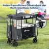 A group of people are in the background, and a wagon is in the foreground, filled with items. Produktbild-Vorschau