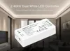 A white LED controller is shown in the foreground, with a blurred background of a modern living room with ceiling lights. Produktbild-Vorschau
