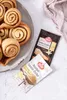 A plate of cinnamon rolls next to two packets of RUF brand baking sugar. Produktbild-Vorschau