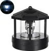 A black solar-powered lighthouse lamp with a clear glass cylinder and a rotating light inside. Anteprima dell’immagine prodotto