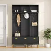 A black entryway hall tree with gold accents, featuring shelves, hooks, and drawers, is shown in a well-lit room next to a white door and a potted plant. Anteprima dell’immagine prodotto