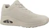 A side view of a beige SKECHERS UNO sneaker with a visible air cushion in the sole. Voir les images du produit